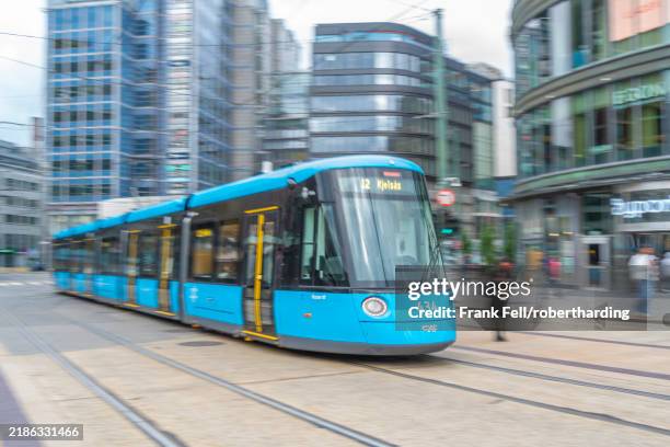view of moving city tram in jernbanetorget, oslo, norway, scandinavia, europe - pedestrian zone stock pictures, royalty-free photos & images