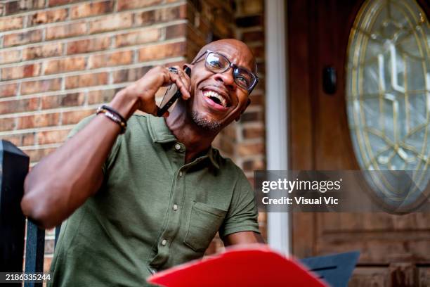 joyful veteran on phone outdoors - north carolina porch stock pictures, royalty-free photos & images