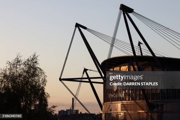 Photograph taken on November 26, 2024 shows the Etihad Stadium in Manchester, north west England, lighten up by the sunset light prior to the UEFA...