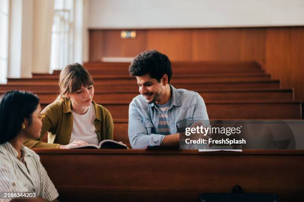 diverse students engaged in collaborative learning in lecture hall - college admission stock pictures, royalty-free photos & images