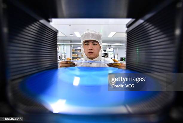 An employee packages semiconductor power devices for export at the intelligent workshop of a semiconductor manufacturing enterprise on November 22,...