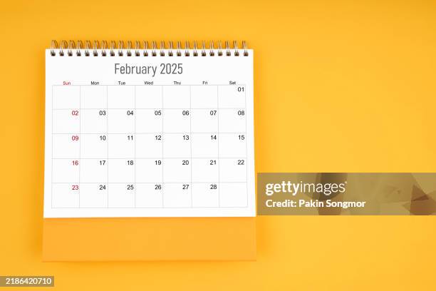 february 2025 desk calendar on yellow color background, for your appointment text. - febrero fotografías e imágenes de stock