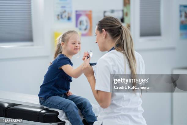 pediatric appointment - down syndrome stock pictures, royalty-free photos & images