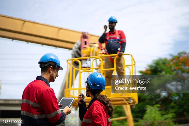 engineers are working at construction site. - mobile crane stock pictures, royalty-free photos & images