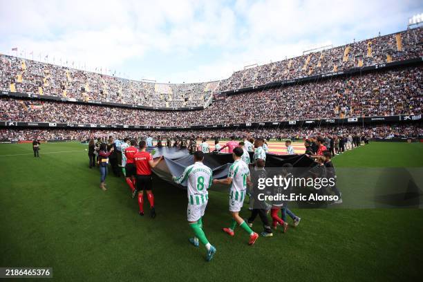 General view inside the stadium as flags are carried onto the pitch prior to the LaLiga match between Valencia CF and Real Betis Balompie at Estadio...
