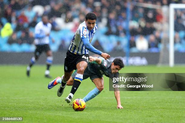 Shea Charles of Sheffield Wednesday breaks away from Alex Robertson of Cardiff City during the Sky Bet Championship match between Sheffield Wednesday...