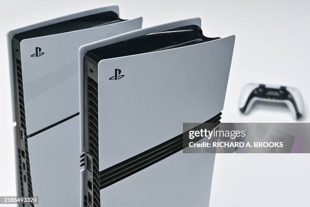 This photo illustration shows a Sony PlayStation 5 and 5 Pro on display at the Sony headquarters building in central Tokyo on November 27, 2024....