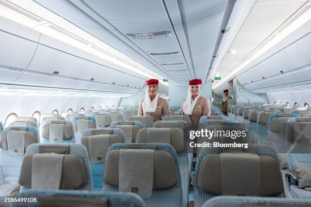 Flight attendants in the Economy Class cabin of an Emirates Airline Airbus A350-900 aircraft during its unveiling at Dubai International Airport in...