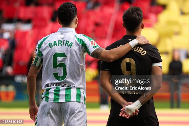 Marc Bartra of Real Betis Balompié and Hugo Duro of Valencia CF line up in the middle of the pitch for a minute silence during the LaLiga match...