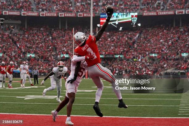 Jeremiah Smith of the Ohio State Buckeyes attempts to make a catch while being guarded by D'Angelo Ponds of the Indiana Hoosiers in the second...