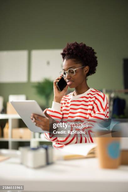 young black woman leading an online apparel business - business talk stock pictures, royalty-free photos & images