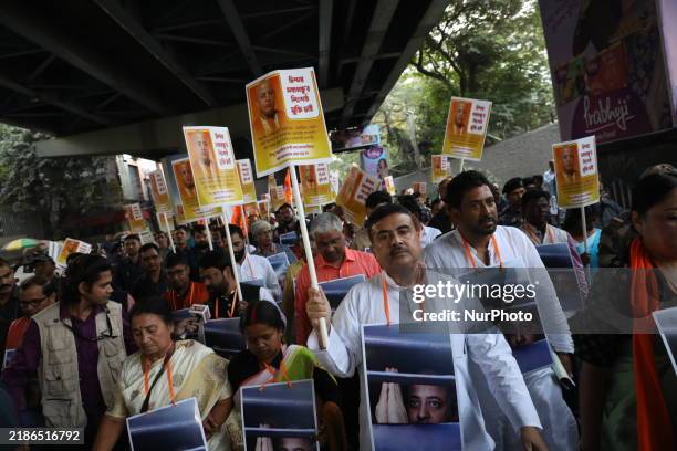 Bharatiya Janata Party activists shout slogans and carry placards during a protest rally towards the Bangladesh High Commission in Kolkata, India, on...