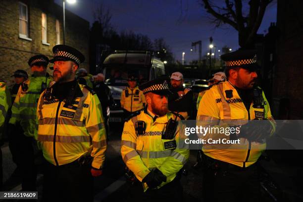 Police officers block a road leading to a Kurdish community centre that was raided by counter-terror police on November 27, 2024 in the London...