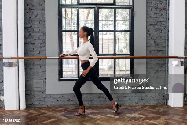 young woman practicing tango in a dance studio - barre stock pictures, royalty-free photos & images