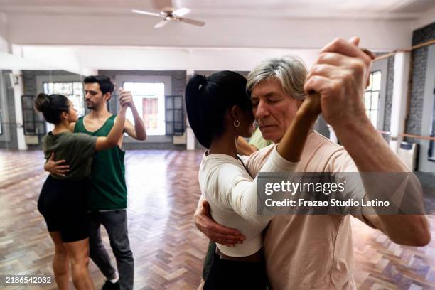 dancers dancing tango in a dance studio - tango stock pictures, royalty-free photos & images