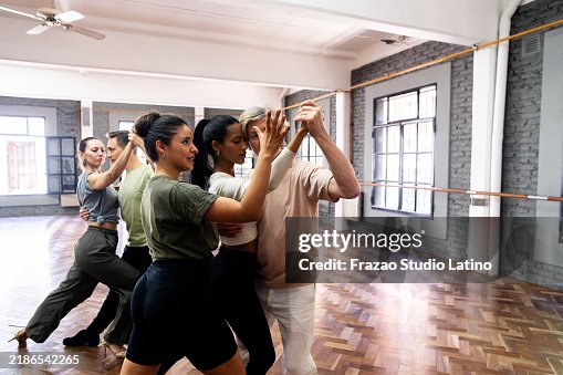 Instructor teaching students during tango class Instructor teaching students during tango class