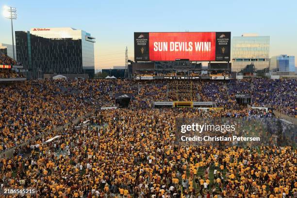 Fans rush the field before a resumption of play with 1 second left on the clock during the NCAAF game between the Arizona State Sun Devils and the...