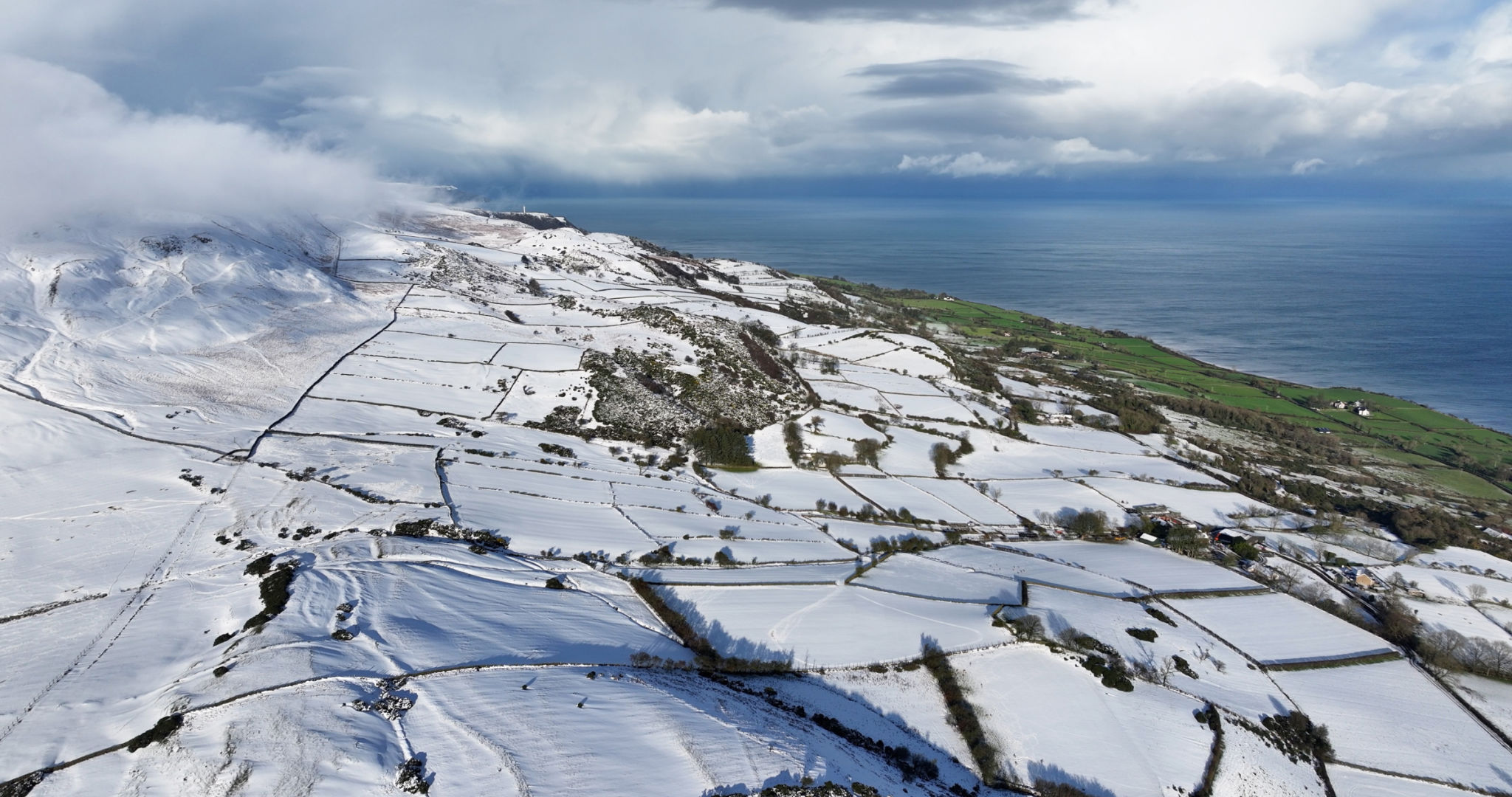 Aerial view of freezing fog on the snowy beautiful and spectacular Rolling hills of the Glens of Antrim Northern Ireland Aerial view of freezing fog on the snowy beautiful and spectacular Rolling hills of the Glens of Antrim Northern Ireland