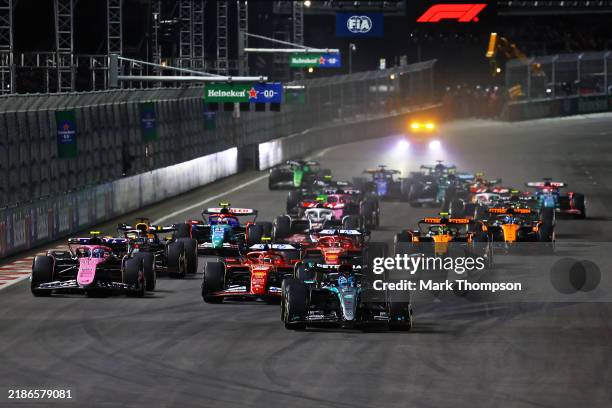 George Russell of Great Britain driving the Mercedes AMG Petronas F1 Team W15 leads the field into the first corner at the start of the race during...