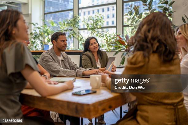 diverse multicultural team collaborating in a bright corporate workspace - minority groups stock pictures, royalty-free photos & images