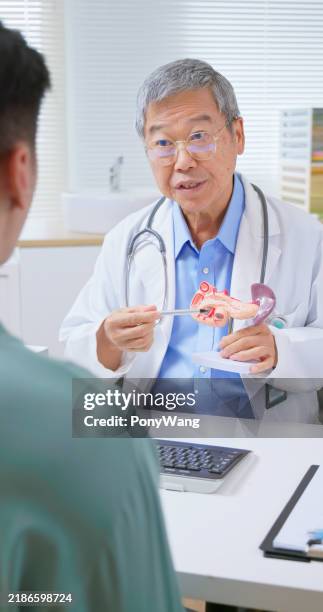 young patient consult elder doctor - pancreatic cancer stock pictures, royalty-free photos & images