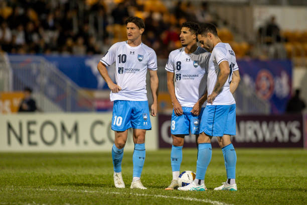 Joseph Lolley, Anas Ouahim, and Anthony Caceres of Sydney FC prepare for the free kick during the AFC Champions League Two Group E match between...