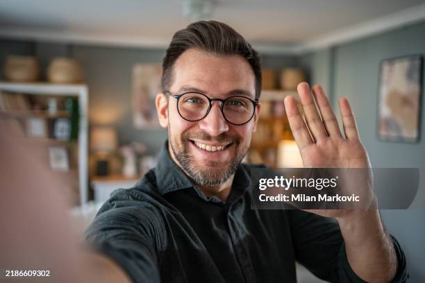 man talking and looking at camera, recording video for his vlog - man webcam stock pictures, royalty-free photos & images