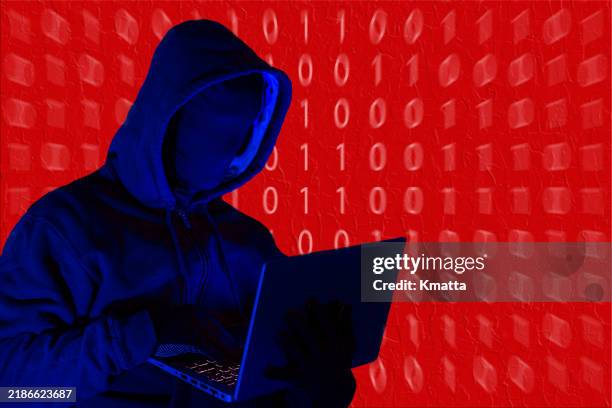 mystery man in silhouette red with binary code background. - hacker stock-fotos und bilder