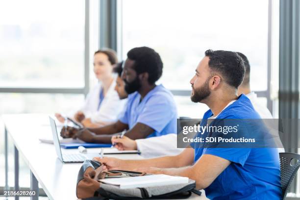 male medical student listens attentively during class - estudante de medicina imagens e fotografias de stock