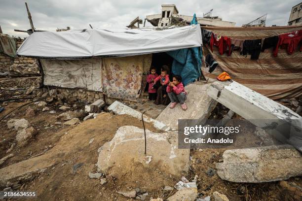Displaced Palestinians near Yarmouk Stadium in Gaza City endure harsh living conditions in makeshift tents, where families, including women and...