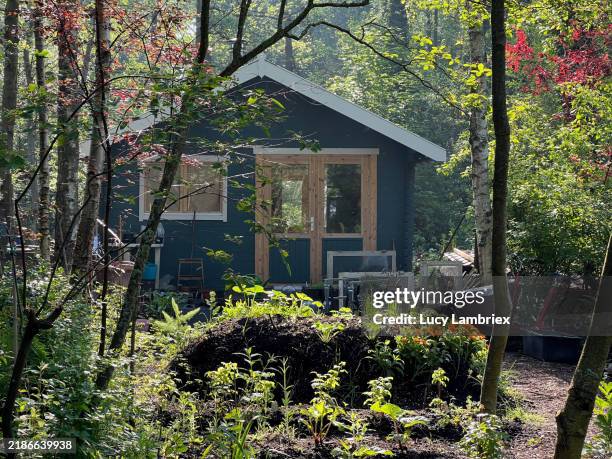 wooden cabin with raised garden bed - log cabin stock pictures, royalty-free photos & images