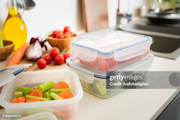 contenants alimentaires en plastique hermétiques remplis de légumes sur le comptoir de la cuisine - récipient photos et images de collection