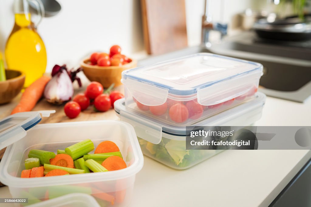 Airtight plastic food containers filled with vegetables on kitchen counter