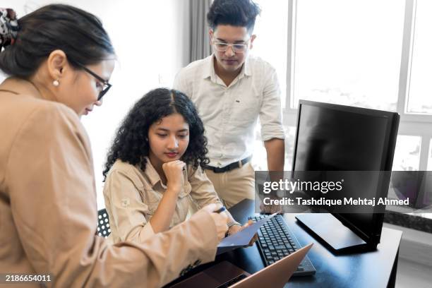 group of co-workers working together. - south asia stock pictures, royalty-free photos & images