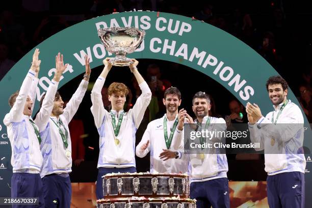 Filippo Volandri, Jannik Sinner, Lorenzo Musetti, Matteo Berrettini, Andrea Vavassori and Simone Bolelli of Italy lift the Davis Cup Trophy after...