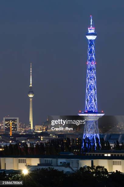 berlin city skyline with blue illuminated tv-tower (funkturm) and television-tower (fernsehturm) - germany - grunewald berlin stock pictures, royalty-free photos & images