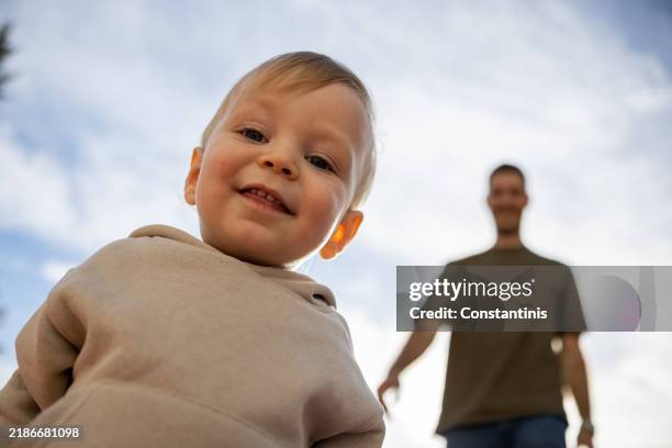 smiling baby boy looking at camera - greater manchester stock pictures, royalty-free photos & images