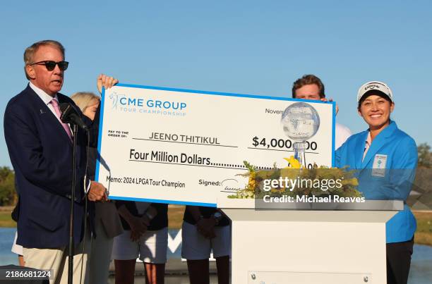 Terrence A. Duffy, CEO of CME Group, presents Jeeno Thitikul of Thailand with a check for $4 million after the final round of the CME Group Tour...