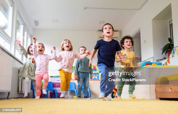children running towards the camera - kinderopvang stockfoto's en -beelden