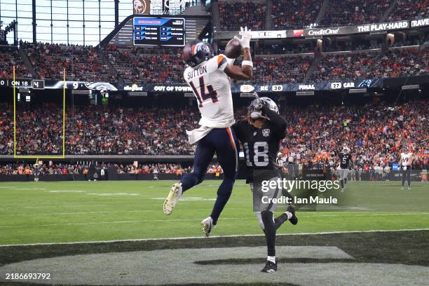 Courtland Sutton of the Denver Broncos catches a pass in front of Jack Jones of the Las Vegas Raiders for a touchdown during the third quarter at...