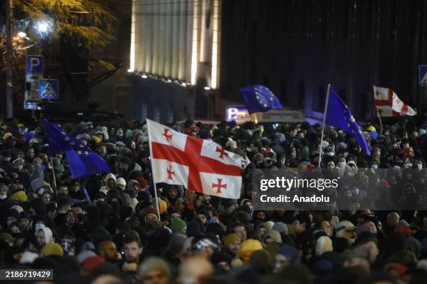 Security forces take measures and use tear gas canisters as thousands of Georgian protesters gather outside the parliament building to oppose the...