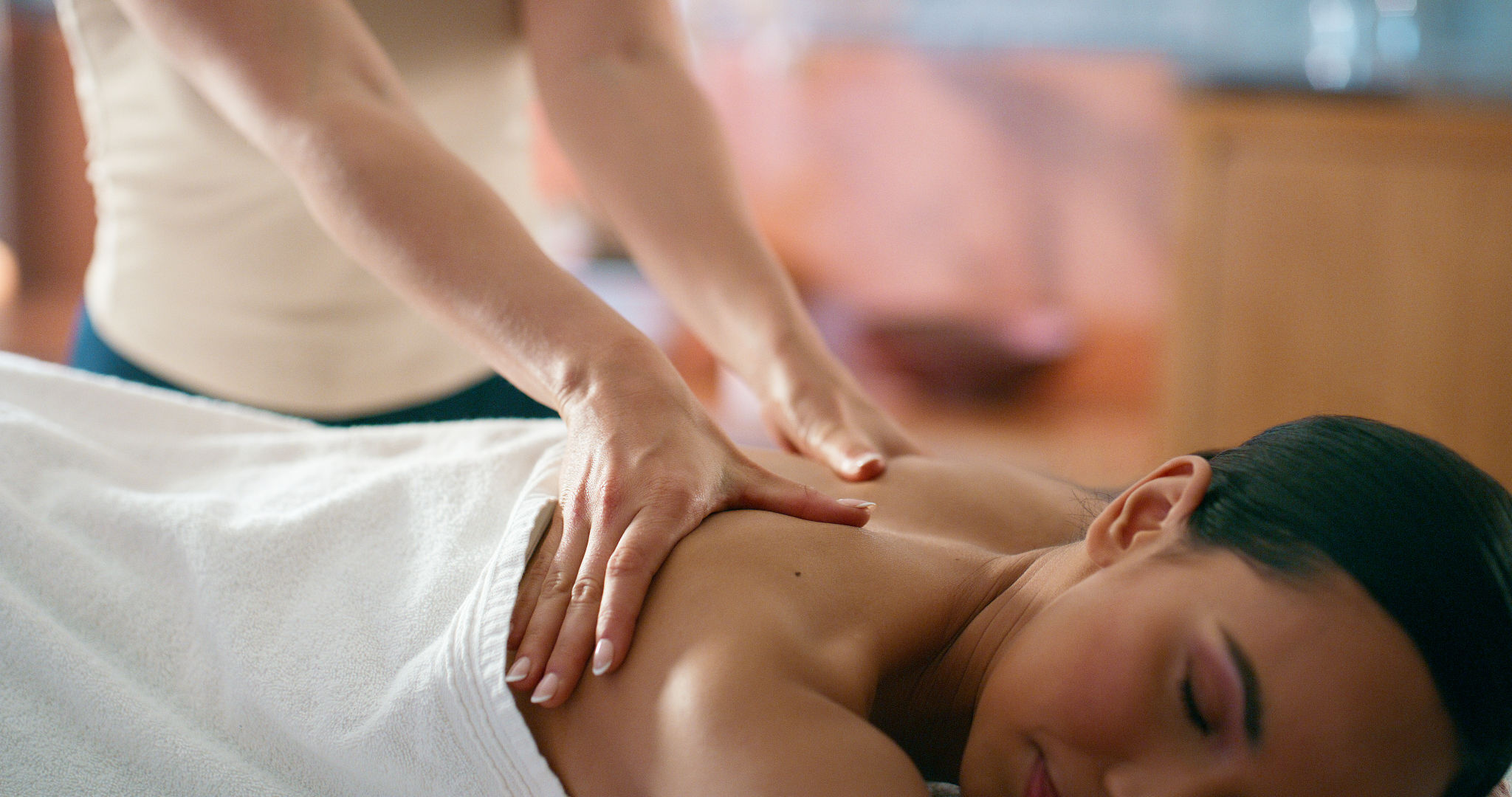Woman, hands and back massage in hotel for wellness, muscle tension and stress relief with service of masseuse. Female person, peace and therapeutic healing in spa for relax, treatment and self care Woman, hands and back massage in hotel for wellness, muscle tension and stress relief with service of masseuse. Female person, peace and therapeutic healing in spa for relax, treatment and self care