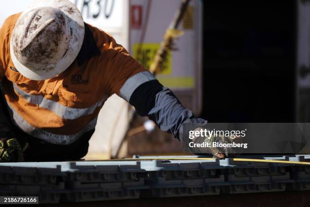 Drill rig worker measures core samples at BHP Group Ltd.'s Oak Dam exploration site in Kokatha, South Australia, Australia, on Tuesday, July 23,...