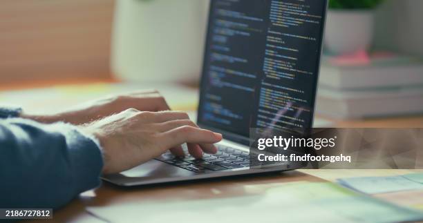close-up of hands coding on a laptop. - code stockfoto's en -beelden