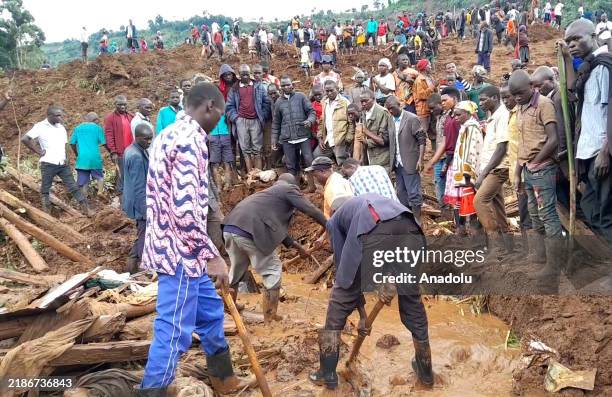 Locals continue search and rescue efforts at the site of the landslide caused by heavy rains, which reportedly killed 15 people and left at least 113...
