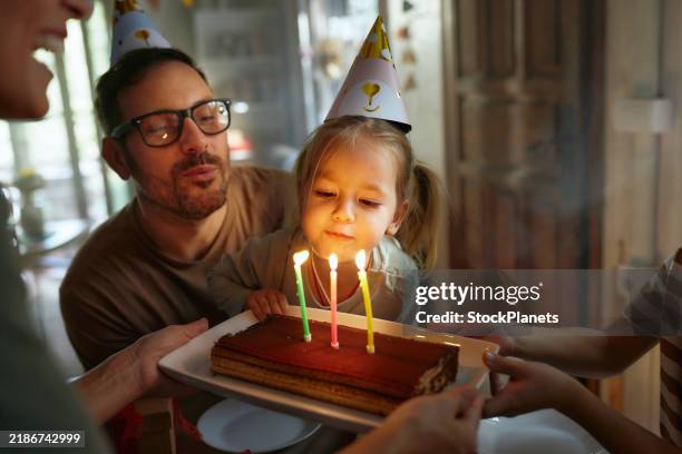 blowing birthday candles on a cake! - birthday candle stock pictures, royalty-free photos & images
