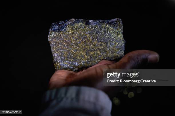 a person holding a piece of copper ore - zambia stockfoto's en -beelden