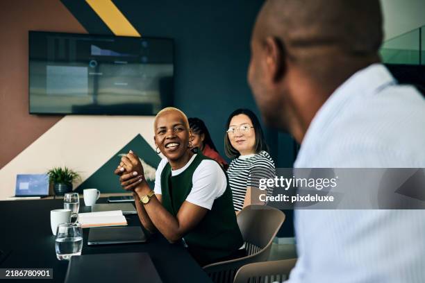 diverse business team celebrating success during meeting in modern office - achievement stock pictures, royalty-free photos & images