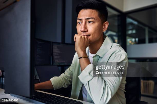 young asian man working as software developer, coding on computer in modern office - web designer imagens e fotografias de stock