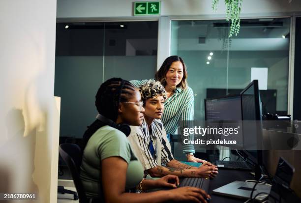 team of programmers working on code at night in office - web designer stock pictures, royalty-free photos & images